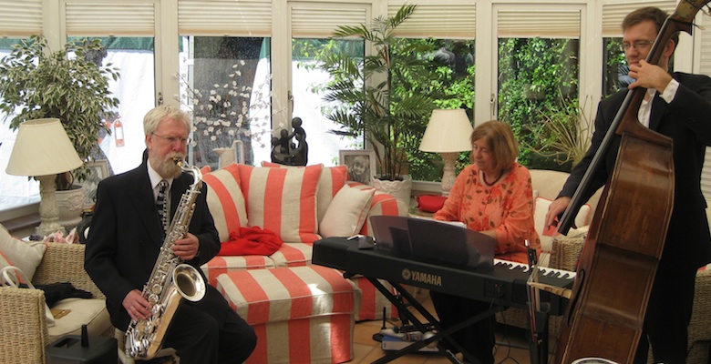The Abbey Jazz Trio playing in a conservatory at a garden party