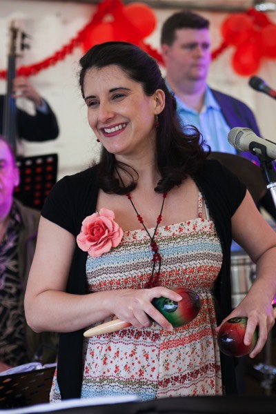 Cuban singer Dunia playing maracas at a birthday party in Wiltshire
