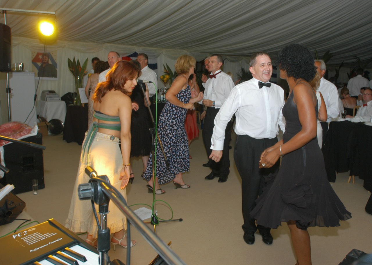 Guests dancing to live latin band Jan y su Salsa at a corporate party in Gloucestershire. Singer Taide in left foreground.