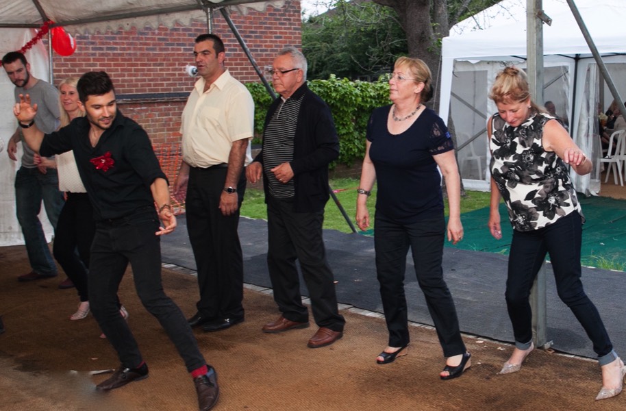 Salsa Dancer teaching guests at a party while our live salsa band plays