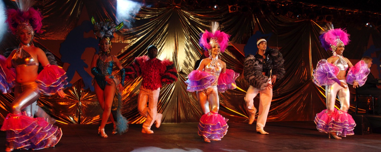 Dancers in Tropicana costume doing the cha cha cha to our live salsa band